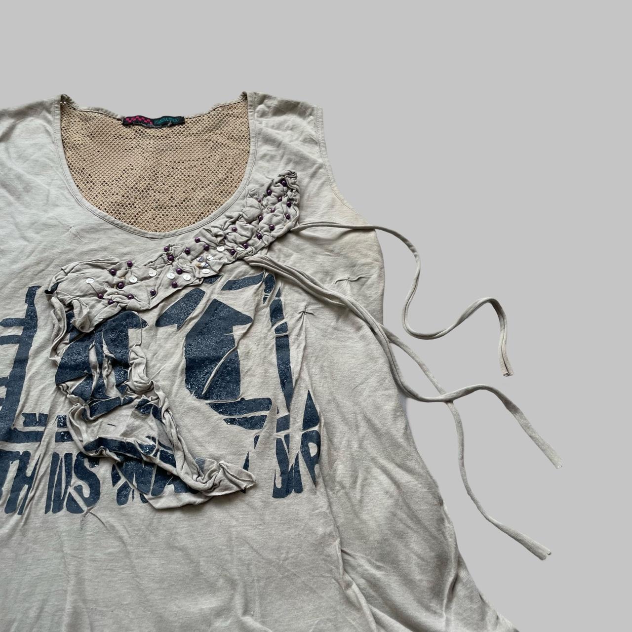Beige double layered distressed tank top.