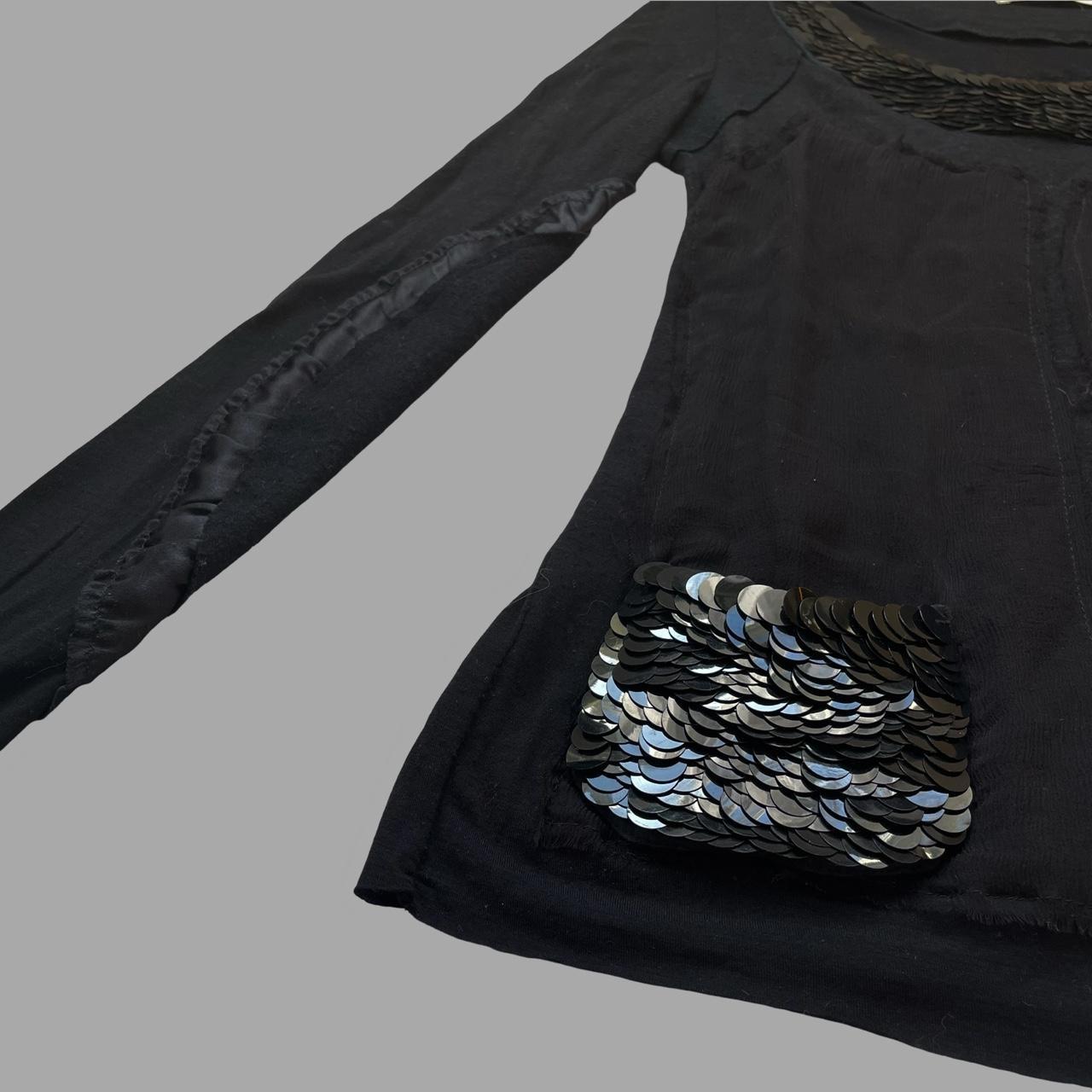 Multi-fabric patchwork black top with sequins.