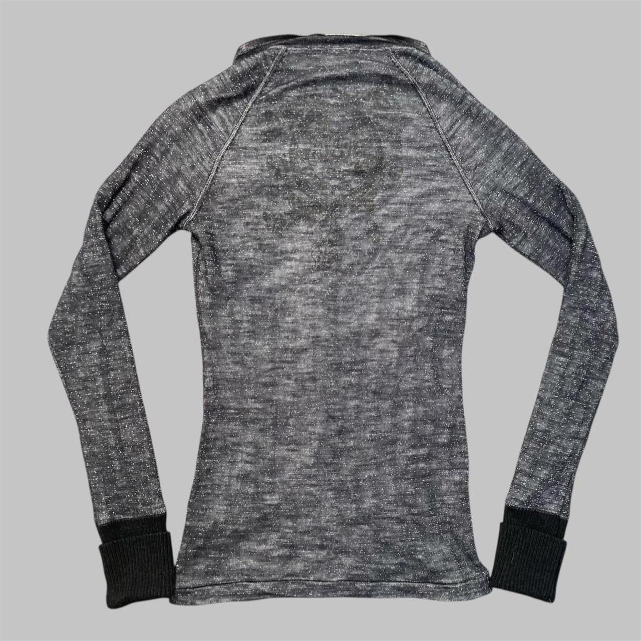 Italian knit top with removable brooch.