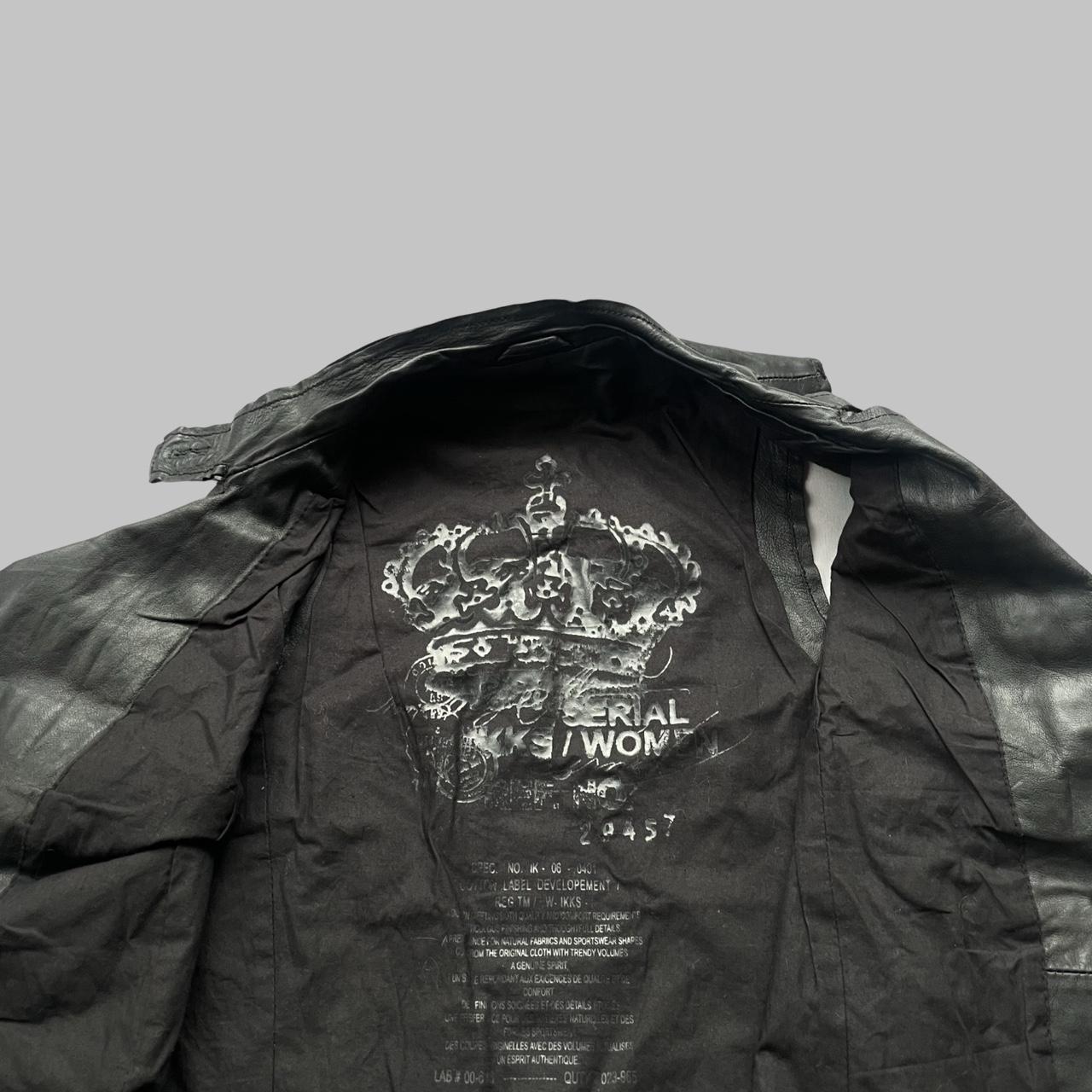 Sleeveless black leather officer jacket.