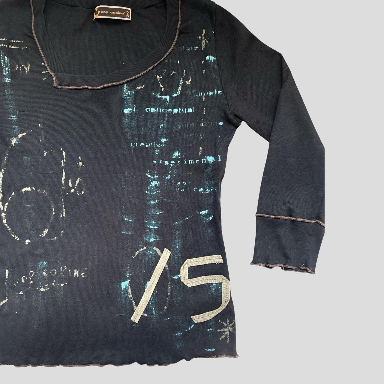 Cop copine black top with abstract graphic.