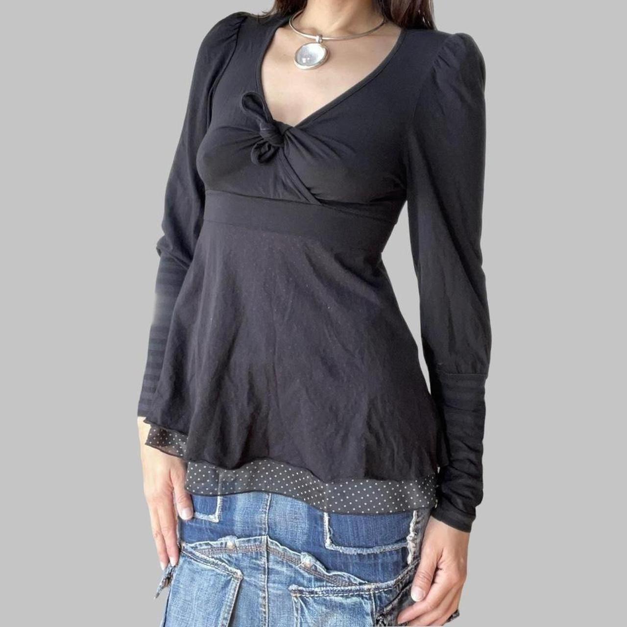 Cop copine black top with striped sleeves.