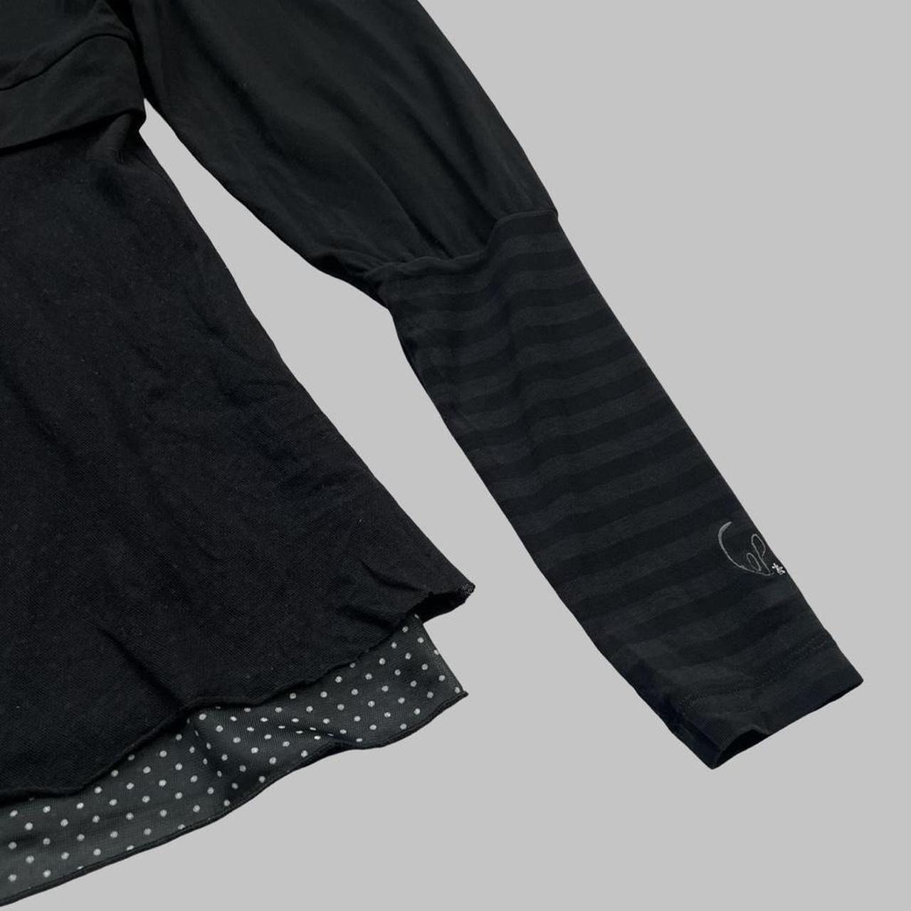 Cop copine black top with striped sleeves.