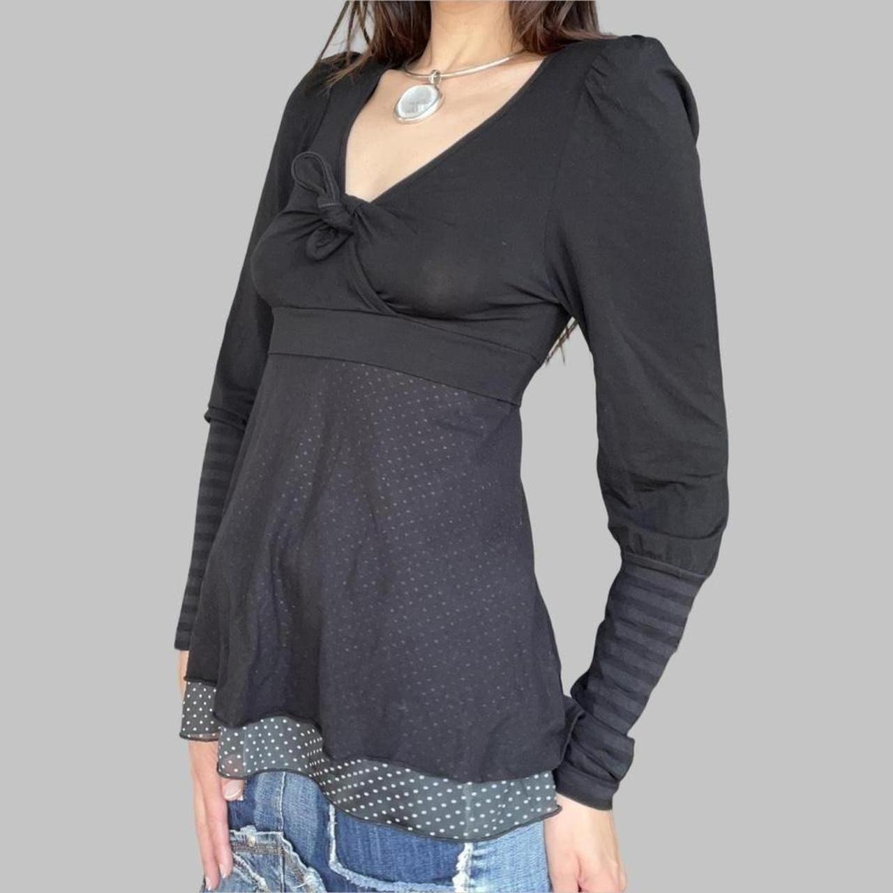 Cop copine black top with striped sleeves.