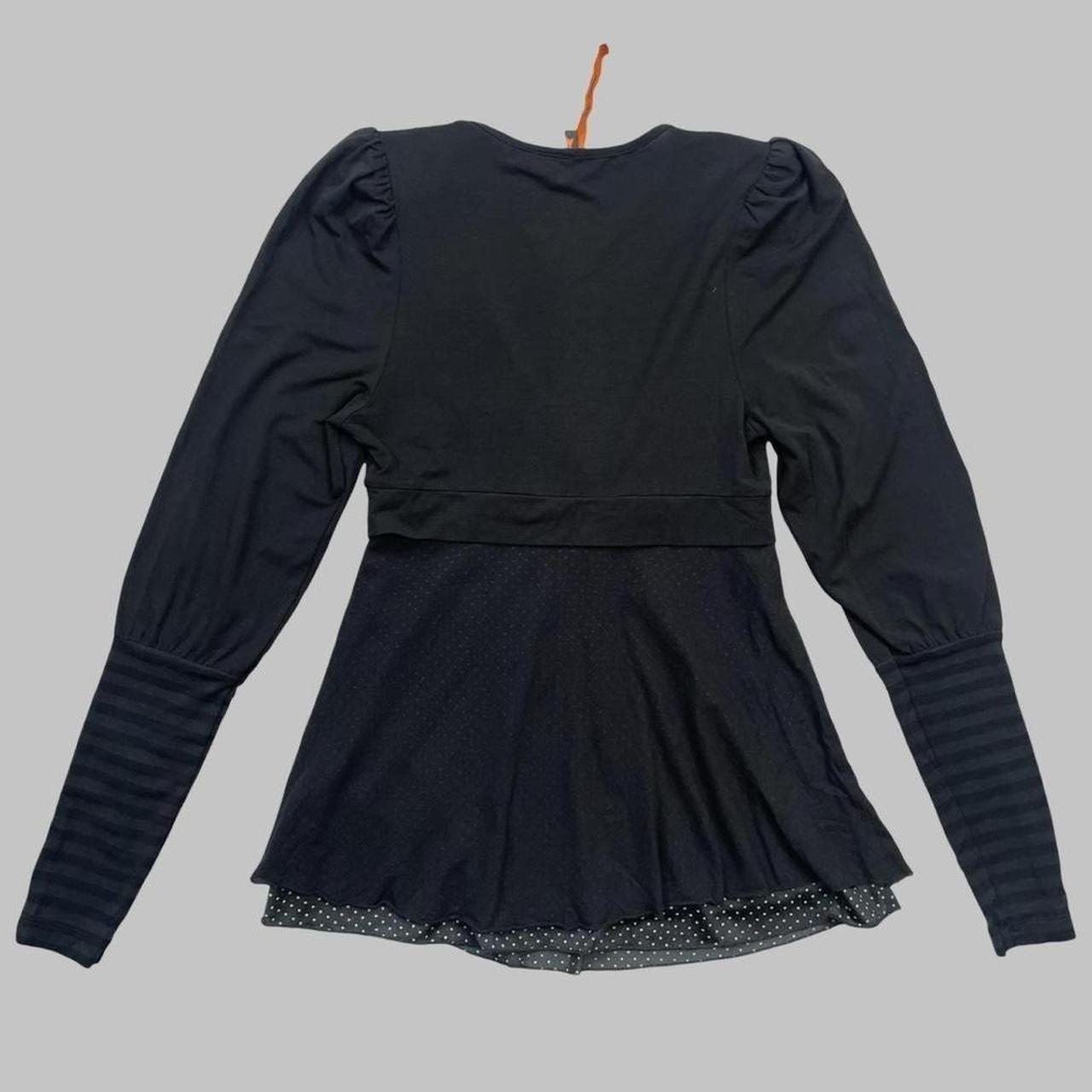 Cop copine black top with striped sleeves.