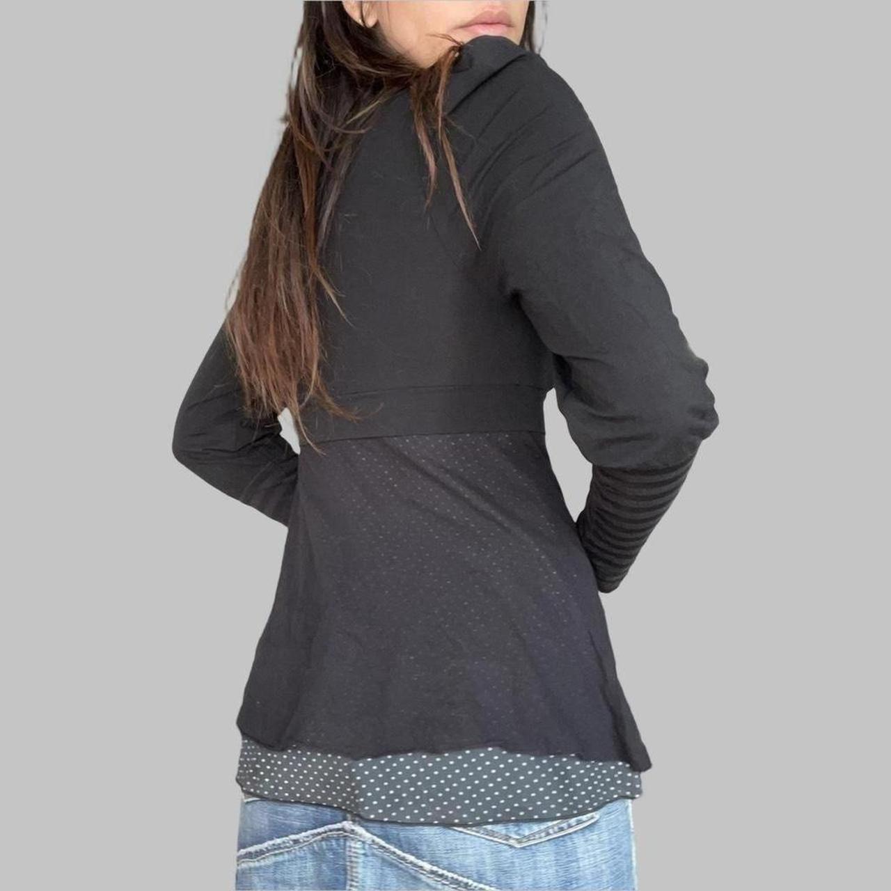 Cop copine black top with striped sleeves.