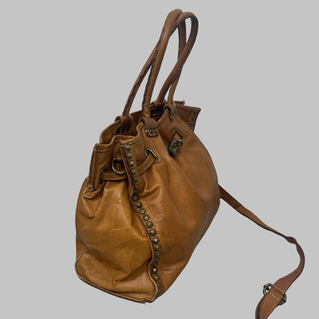 01 - Large cognac leather studded firkin bag.