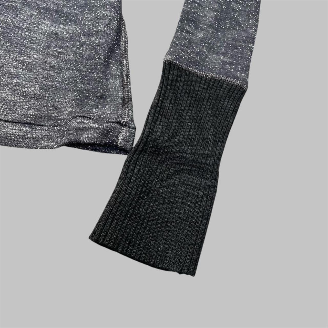 Italian knit top with removable brooch.