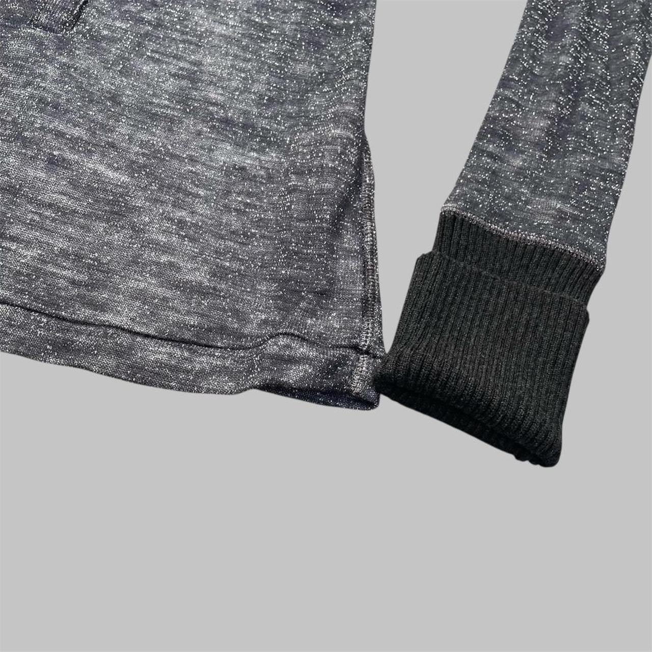 Italian knit top with removable brooch.