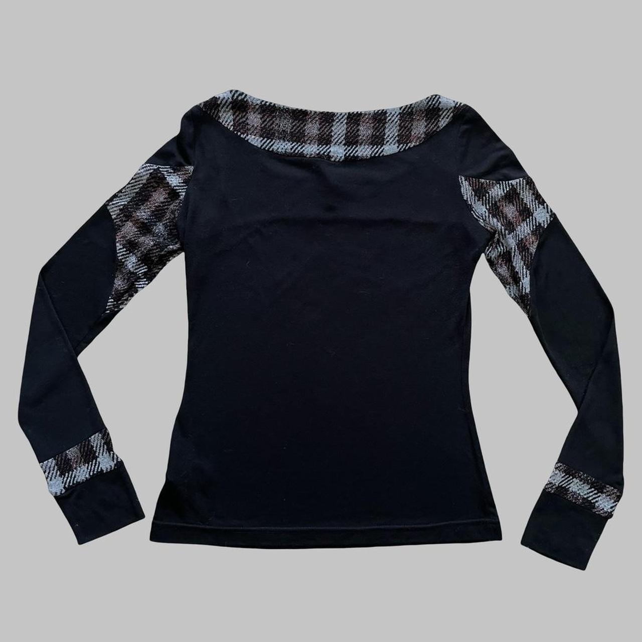 Italian black long-sleeve top with black and plaid motif.